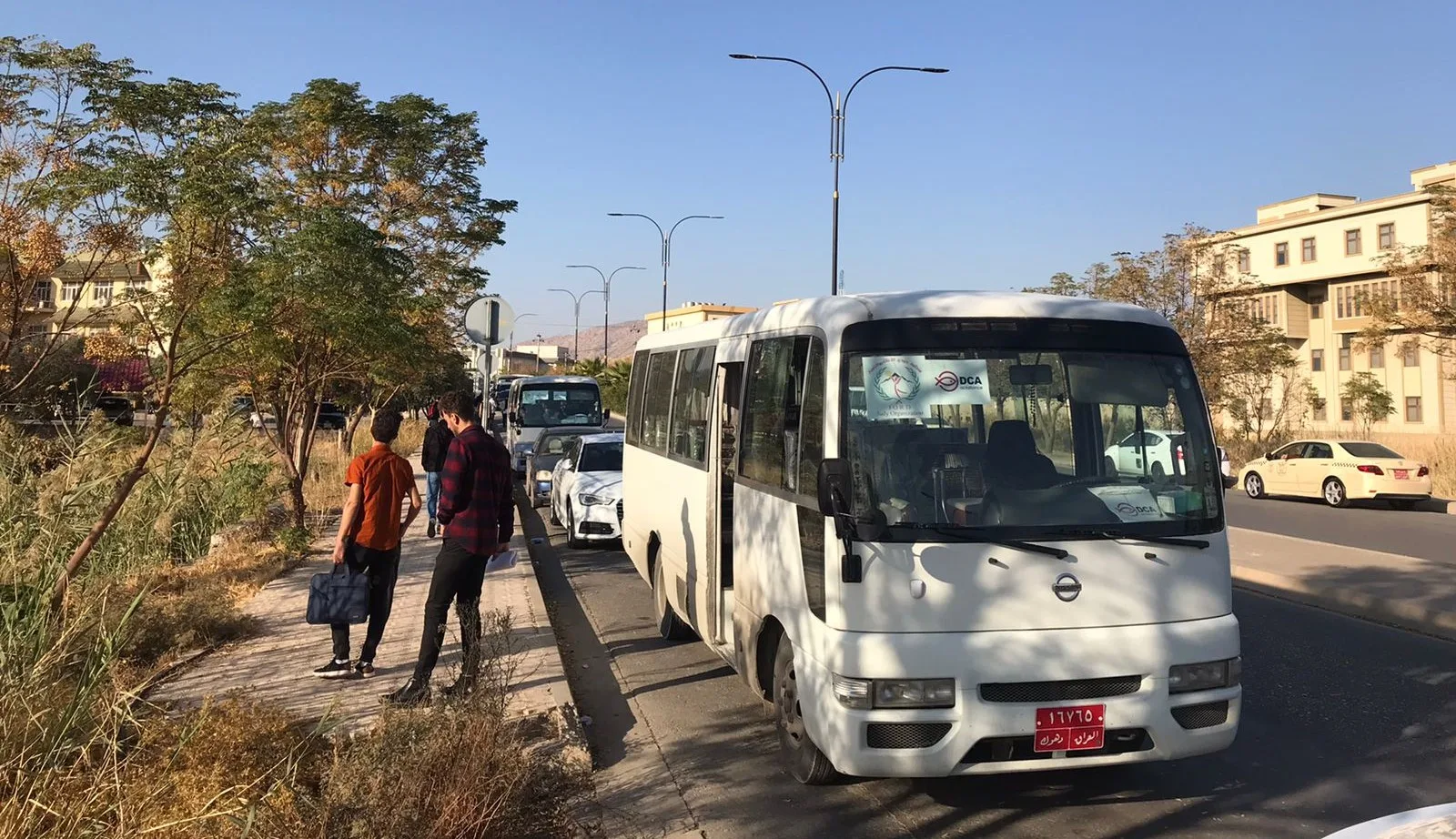 Students stepping out of a transportation buss